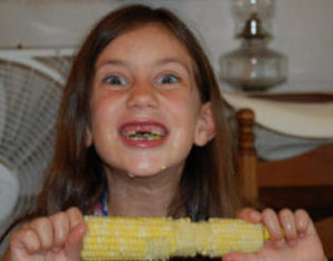 Girl eating corn on the cob